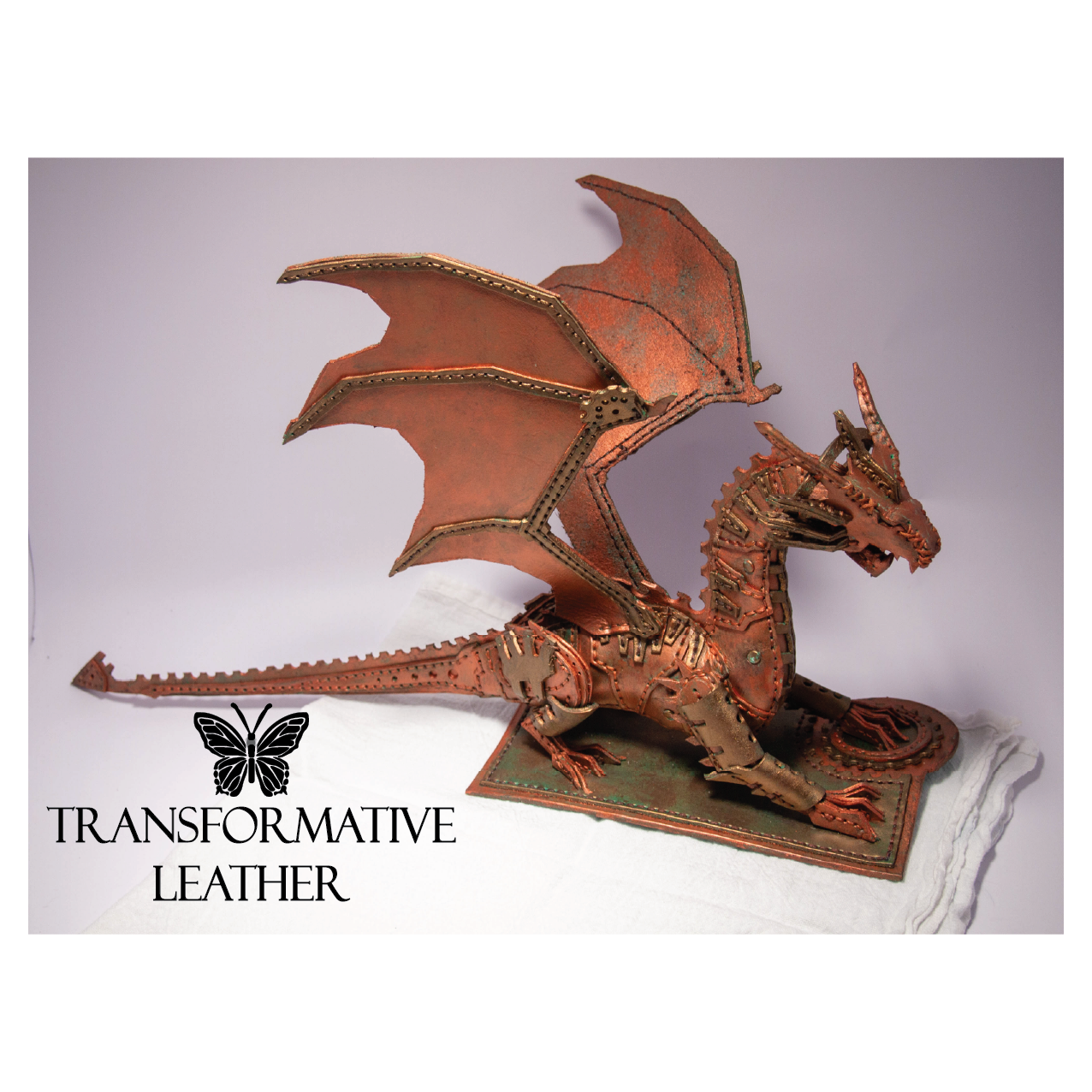 A copper-colored steampunk dragon sculpture made from stitched leather